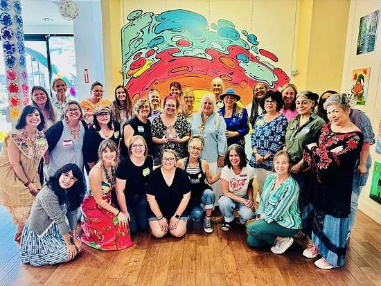 Group photo from the Girl on Fire Retreat hosted by Karen Berg of Redoux Interiors with DIY Paint and Iron Orchid Designs (IOD) — a joyful community of women creatives gathered for painting, inspiration, and connection.