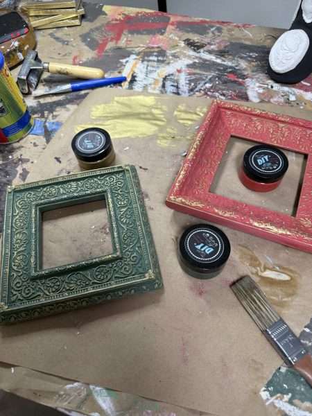 In-progress photo of upcycled vintage frames painted with DIY Paint by Karen Berg of Redoux Interiors — creative holiday makeover using layered colors and Iron Orchid Designs (IOD) finishes.
